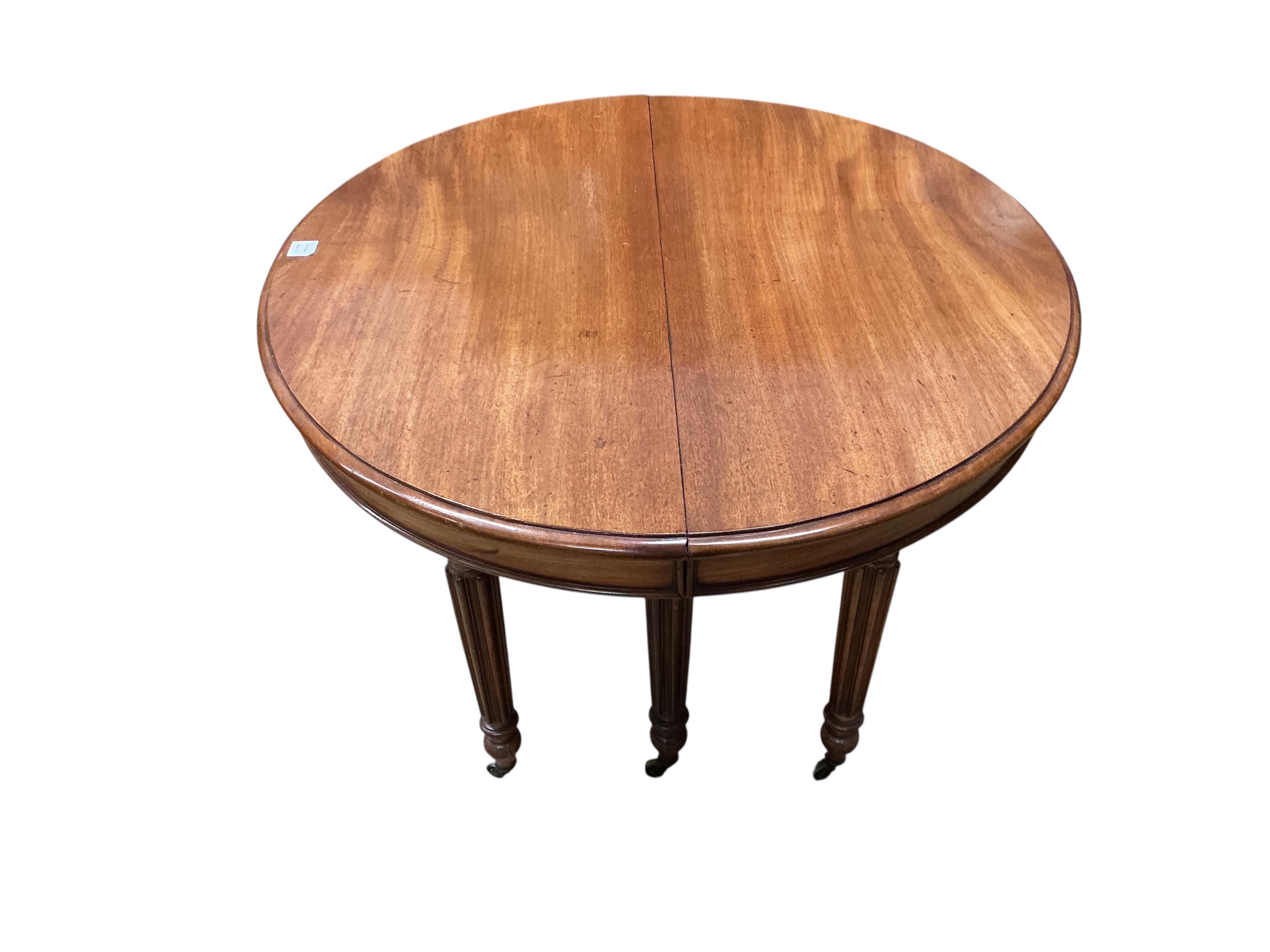 A 19th century French oval mahogany extending dining table, length 214cm extended, two spare leaves, width 102cm, height 70cm